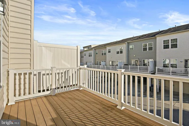 a view of a hallway with wooden floor and entryway