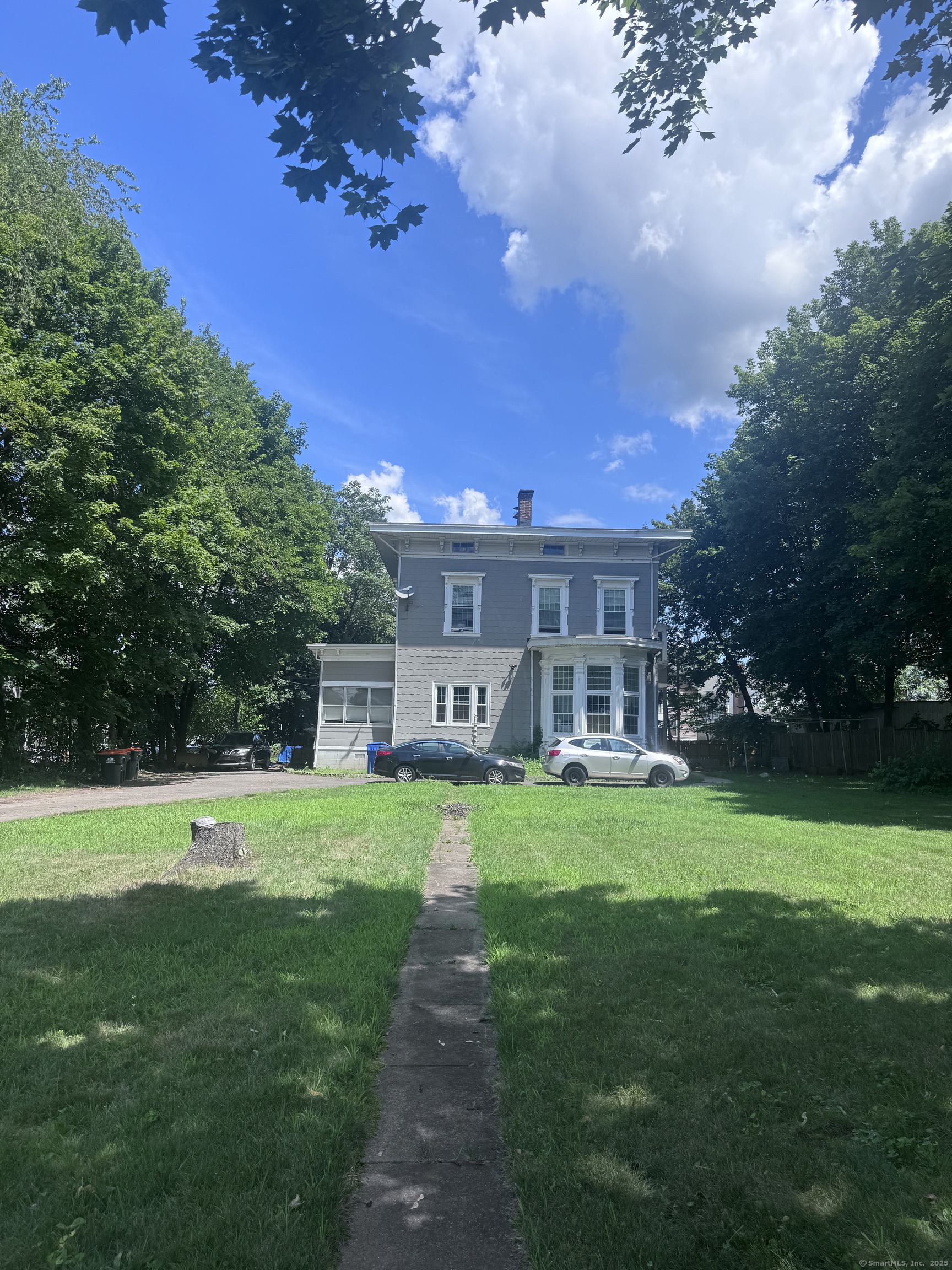 a front view of a house with a garden