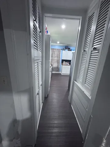 a kitchen with a sink dishwasher a stove and a refrigerator with wooden floor