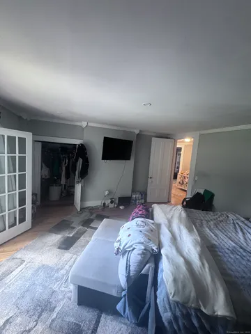 a bedroom with furniture and a window