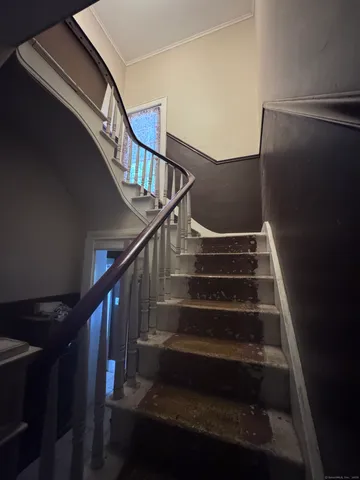 a living room with furniture and a kitchen stove