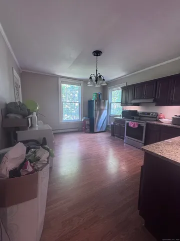 a view of entryway and hall with wooden floor
