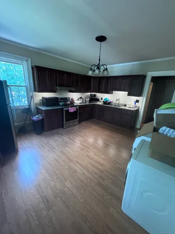 a living room with furniture and a chandelier