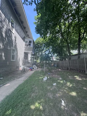 a view of a yard with a house and a tree