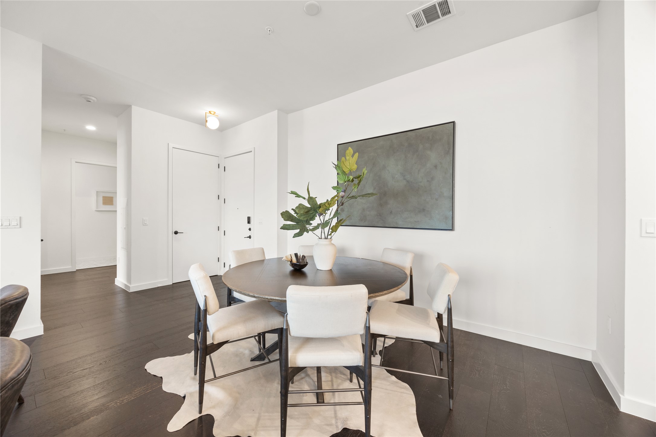 800 Embassy Drive, Unit 602 Austin, TX 78702 - Photo 13 of 37 Dining area featuring dark wood-finish flooring and bright white walls
