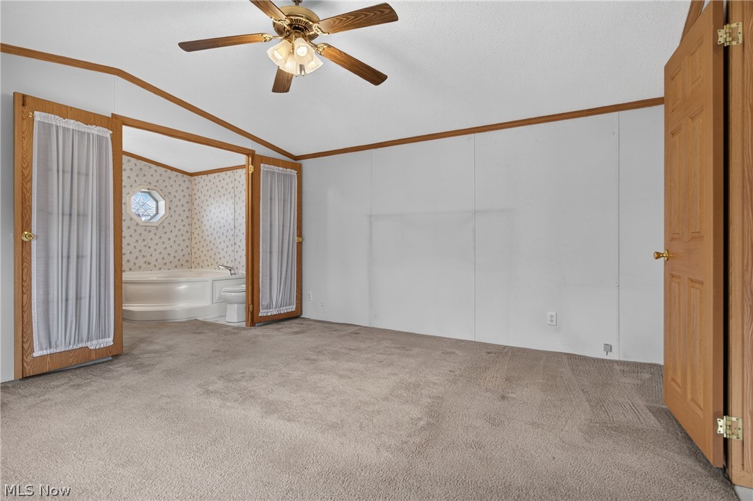 35157 Center Ridge Road, Unit 153 North Ridgeville, OH 44039 - Photo 26 of 35 Spacious room featuring carpeting, a ceiling fan with light fixture, and wood-finish trim