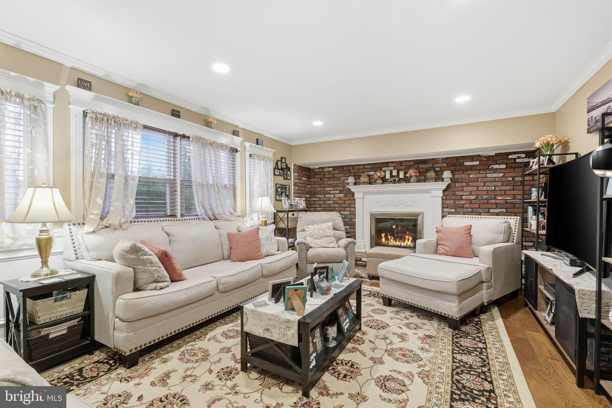 103 Greenvale Road Cherry Hill, NJ 08034 - Photo 16 of 36 a living room with furniture and a fireplace