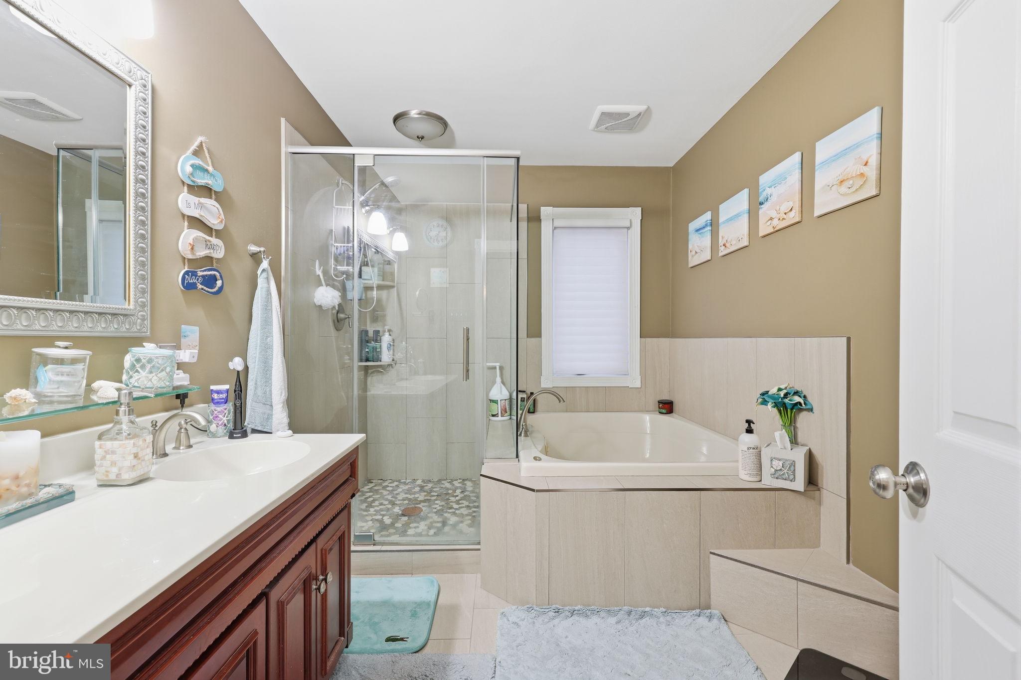 103 Greenvale Road Cherry Hill, NJ 08034 - Photo 27 of 36 a bathroom with a sink a bathtub a mirror a vanity and a shower