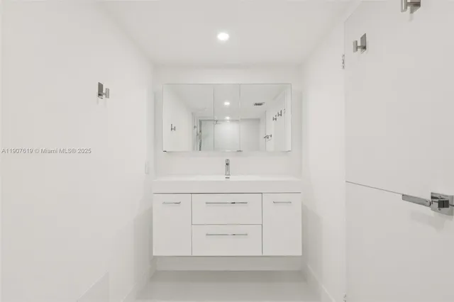 a spacious bathroom with a sink a mirror and a shower