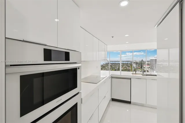 a kitchen with stainless steel appliances a stove microwave and cabinets