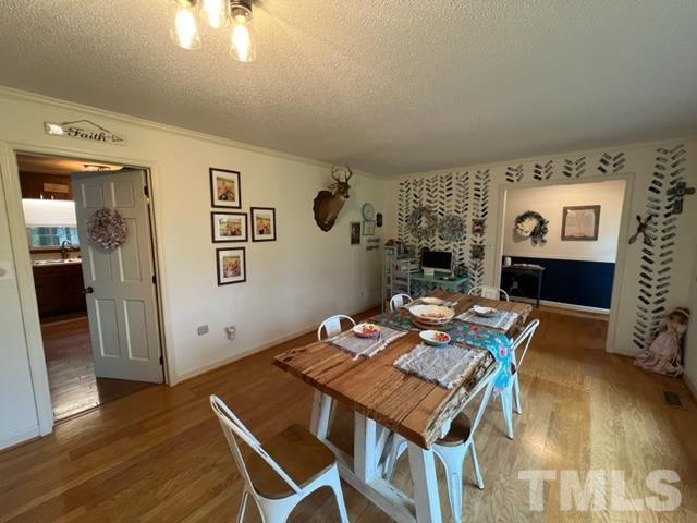 866 Lane Road Dunn, NC 28334 - Photo 14 of 41 a view of a dining room with furniture and wooden floor
