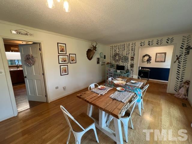 866 Lane Road Dunn, NC 28334 - Photo 15 of 41 a workspace with furniture and wooden floor