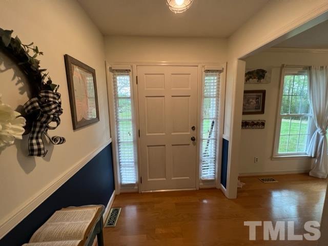 866 Lane Road Dunn, NC 28334 - Photo 16 of 41 a view of a hallway with wooden floor and windows