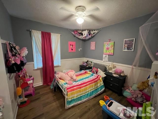 866 Lane Road Dunn, NC 28334 - Photo 19 of 41 a bedroom with a bed and a chandelier