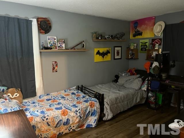 866 Lane Road Dunn, NC 28334 - Photo 22 of 41 a bedroom with bed and wooden floor