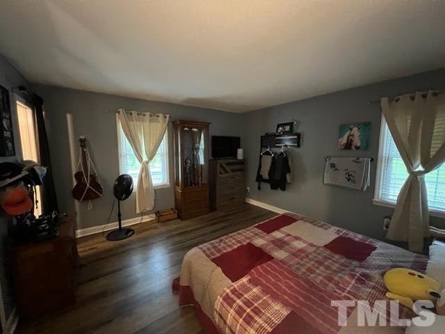 866 Lane Road Dunn, NC 28334 - Photo 24 of 41 a bedroom with a bed and a mirror on the dresser