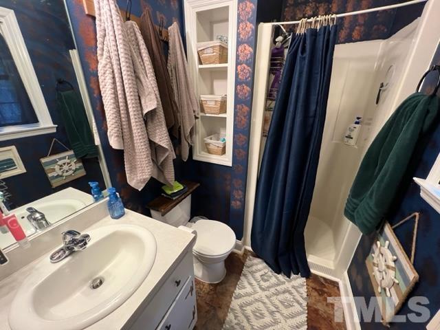 866 Lane Road Dunn, NC 28334 - Photo 26 of 41 a bathroom with a sink and mirror with toilet