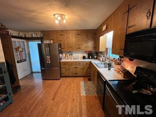 866 Lane Road Dunn, NC 28334 - Photo 31 of 41 a kitchen with refrigerator cabinets and wooden floor