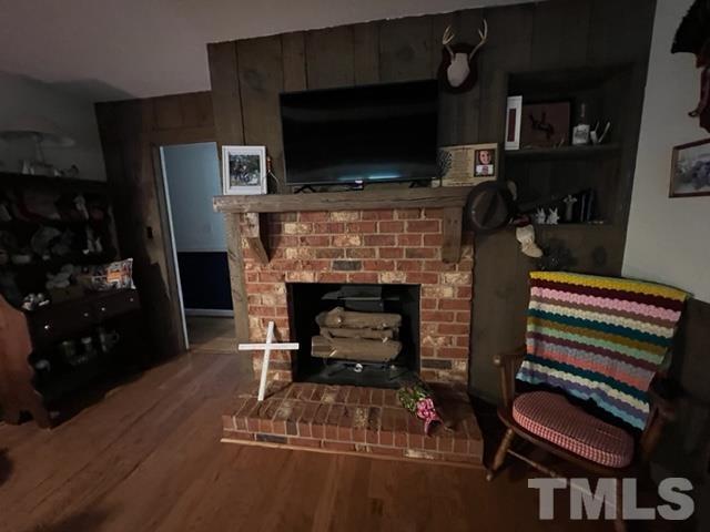866 Lane Road Dunn, NC 28334 - Photo 4 of 41 a living room with furniture a flat screen tv and a fireplace