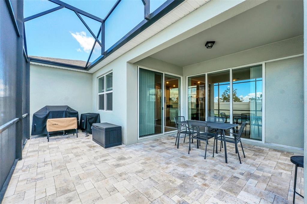 2001 Spring Shower Circle Kissimmee, FL 34744 - Photo 24 of 25 a patio with a table and chairs and potted plants