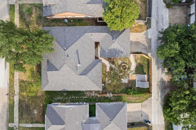 an aerial view of a house with a yard