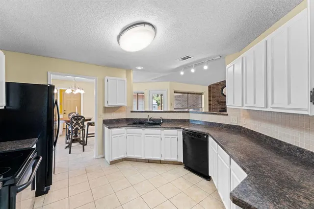 a kitchen with stainless steel appliances granite countertop a stove and a sink