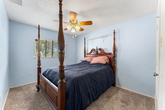 a bed room with a bed and a chandelier