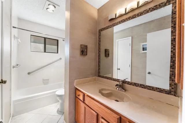 a bathroom with a tub sink and mirror