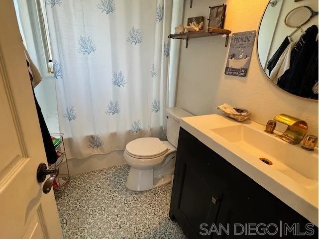 6522 Corte Montecito Carlsbad, CA 92009 - Photo 17 of 29 a bathroom with a sink toilet and shower