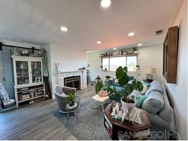 6522 Corte Montecito Carlsbad, CA 92009 - Photo 7 of 29 a living room with furniture fireplace and flat screen tv