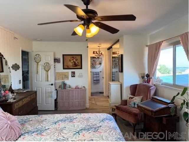 6522 Corte Montecito Carlsbad, CA 92009 - Photo 8 of 29 a bedroom with a bed and wooden floor