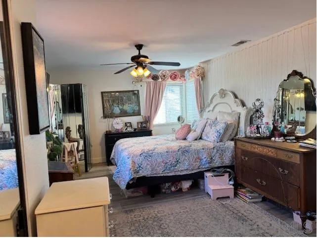 6522 Corte Montecito Carlsbad, CA 92009 - Photo 9 of 29 a bed room with a bed and a chandelier