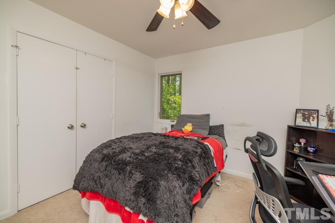 4415 Shadetree Court Raleigh, NC 27613 - Photo 11 of 23 a bed room with a bed and a closet
