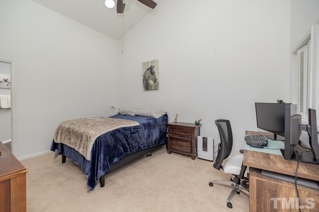 4415 Shadetree Court Raleigh, NC 27613 - Photo 16 of 23 a room with a bed and a desk