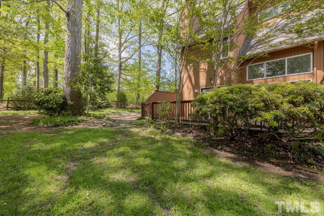 4415 Shadetree Court Raleigh, NC 27613 - Photo 21 of 23 a backyard of a house with table and chairs