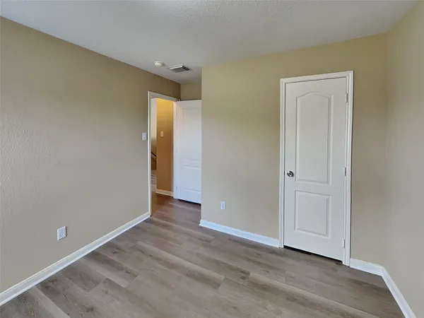 a view of an empty room and wooden floor