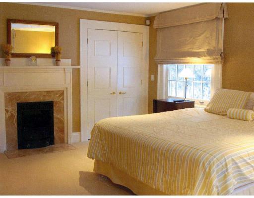 72 Abbott Road Wellesley, MA 02481 - Photo 13 of 18 a bedroom with a bed and a fireplace