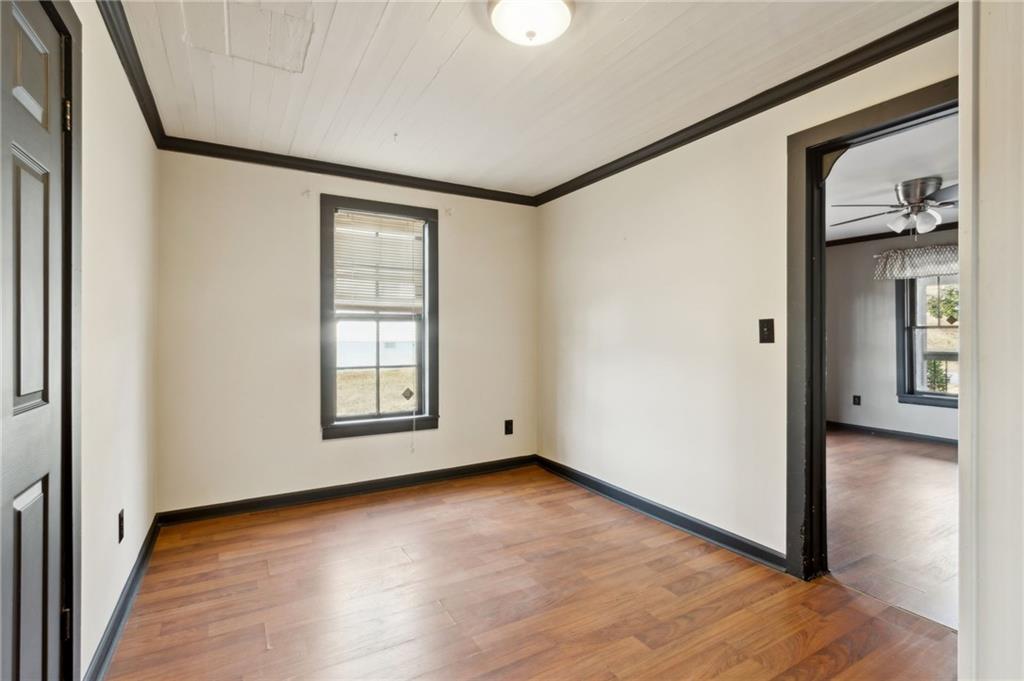 669 Leather Street Buford, GA 30518 - Photo 13 of 46 a view of an empty room with wooden floor and a window
