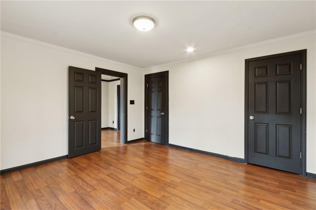 669 Leather Street Buford, GA 30518 - Photo 26 of 46 a view of an empty room with wooden floor