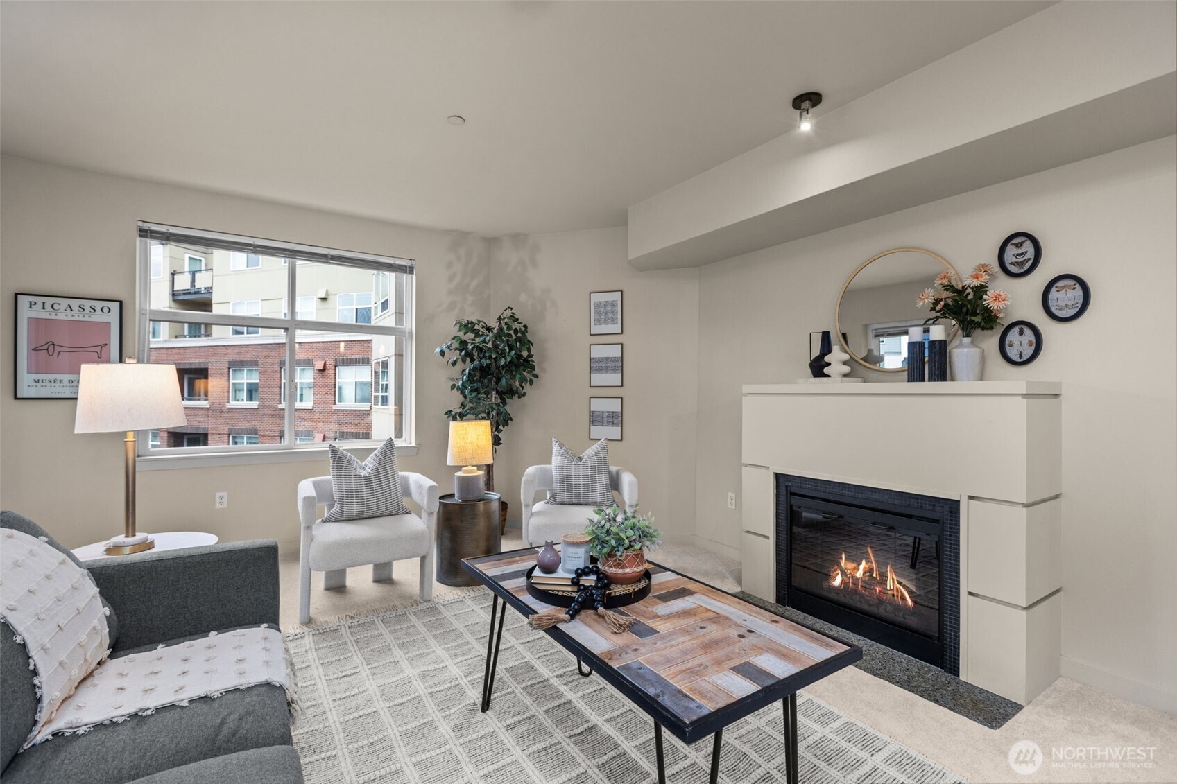 a living room with furniture and a fireplace
