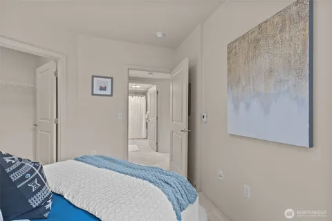 a bedroom with a bed and a painting on the wall