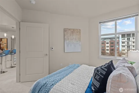 a bedroom with a bed and a window