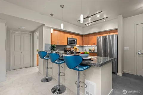 a kitchen with a refrigerator and furniture