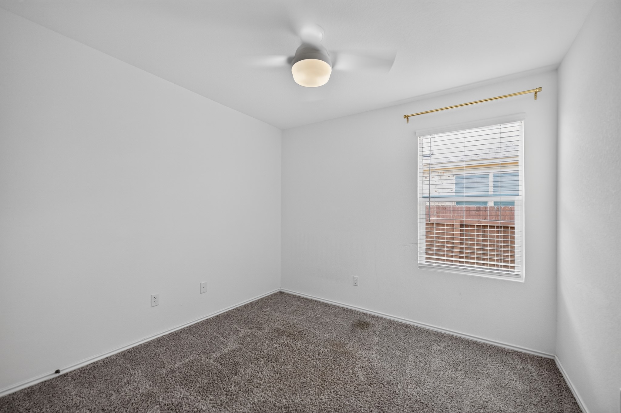 128 Konik Road Georgetown, TX 78626 - Photo 16 of 34 A well-lit bedroom featuring a ceiling fan and soft carpet, ready for personalization.