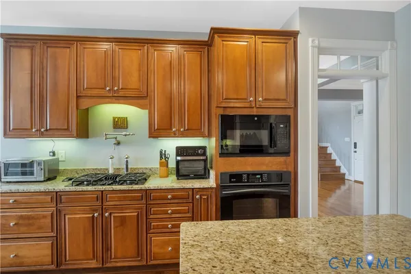 a view of a dining room with furniture wooden floor and chandelier