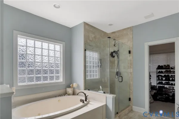 a bathroom with a tub sink and mirror