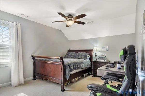 a view of a livingroom with workspace and a window
