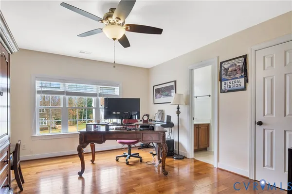 a bathroom with a granite countertop toilet sink and mirror