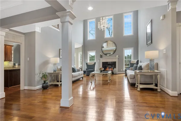 a living room with fireplace furniture and a wooden floor