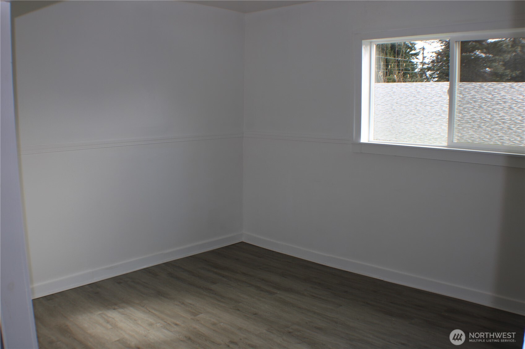 1224 4th Street Cosmopolis, WA 98537 - Photo 11 of 33 a view of a small space with wooden floor and a window